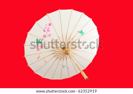 Chinese umbrella isolated on red background.
