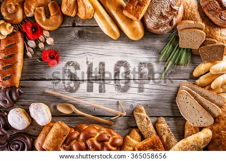 breads, pastries, christmas cake on wooden background with letters, picture for bakery or shop