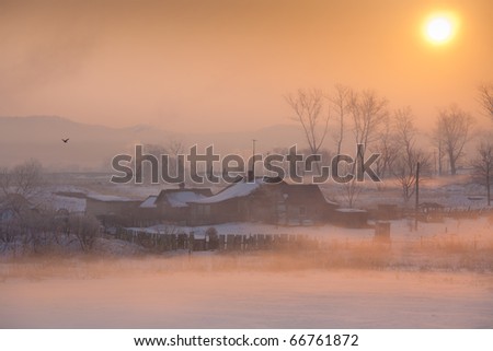 village houses in the background of a beautiful winter sunrise