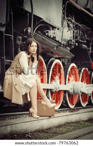 girl waiting for landing on the platform in the vintage train