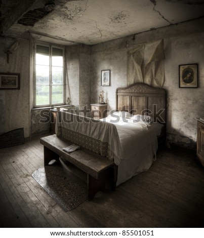 A creepy bedroom scenery, cracked walls and wooden floors along with a religious atmosphere.