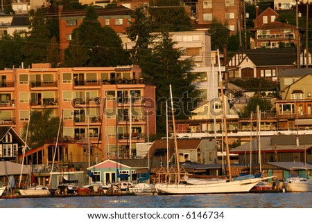 Waterside view of apartment buildings in Seattle, Washington, with sailing boats anchored in front