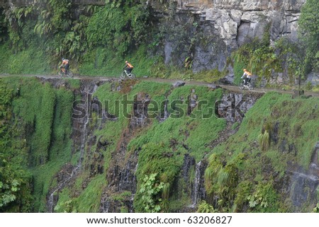 Adventurous bikers riding along the narrow road of death, North Yungas Road, northeast of La Paz, Bolivia