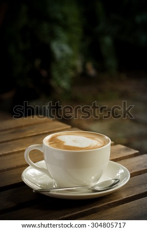 Coffee cup in garden coffee shop - vintage style effect picture