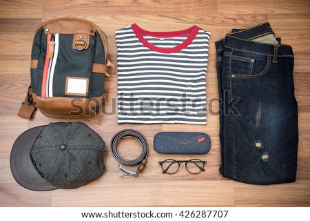 Flat lay photography of men\'s casual outfits, Outfits of traveler, boy, male, Men\'s casual outfits on wood board background