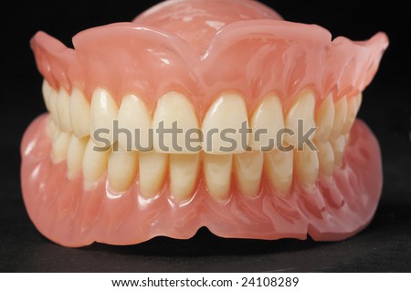 False teeth prosthetic on isolated  black background