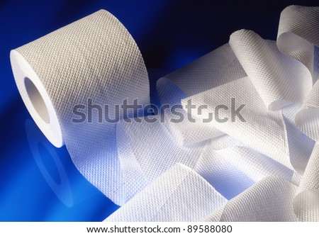 stacked rolls of toilet paper on sky blue background
