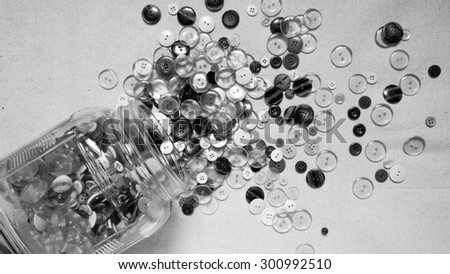 glass jar falling down on the floor and buttons spill away