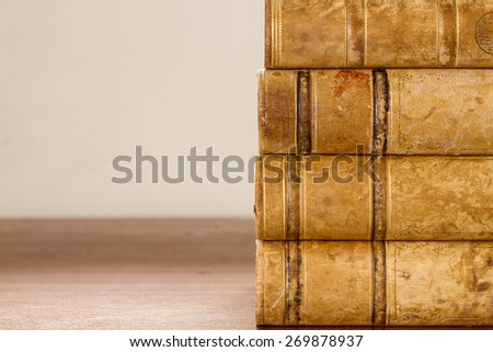 Close up of old books with weathered leather backs