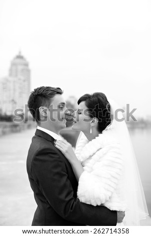 newlyweds smile in embraces