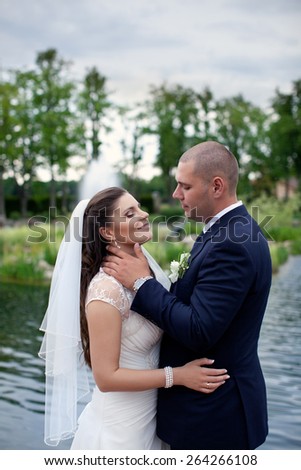 Happy married couple on nature.Beautiful wedding couple.Romantic moment on your wedding day.Newlyweds embracing