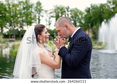The bride and groom looking into each others eyes.Newlyweds smiling.Portrait of the bride and groom.Delicate bridal couple