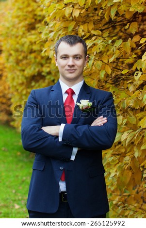 Portrait of the groom in the park on their wedding day.Rich groom on their wedding day