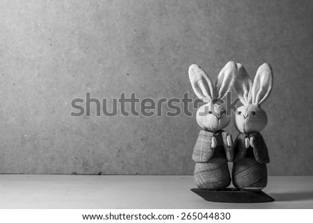 cute couple fabric Japanese rabbits on wooden background. vintage monochrome and still life theme