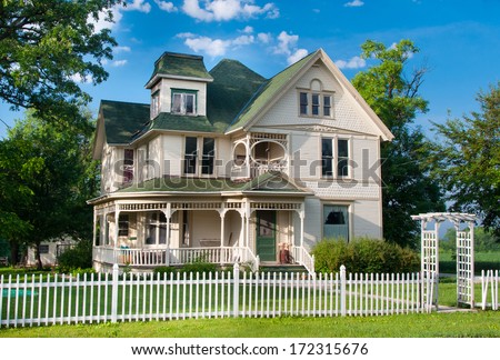 A Beautiful And Well Maintained Two Story Country Home With White Picket Fence Stands On The Edge Of A Small Rural Town In Wisconsin.