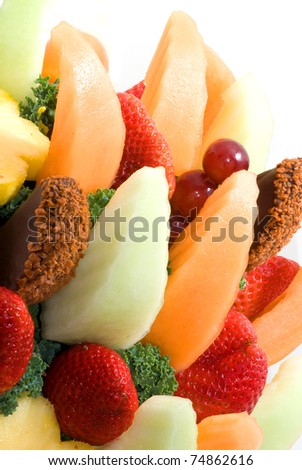 Photograph of an assortment of fresh fruit in a fruit basket, resembling a flower bouquet.