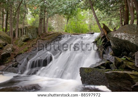 Photograph of a beautiful waterfalls in the Upper Peninsula of Michigan in the late summer, early Autumn period.