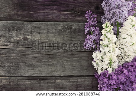 Lilac blossom on rustic wooden background with empty space for greeting message. Mother\'s Day and spring background concept.