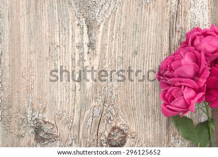Pink flowers roses on rustic wooden background with copy space for greeting message. Mother\'s Day background concept