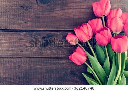 Bouquet of red tulips on a wooden background. Spring flowers. Mother\'s Day background.