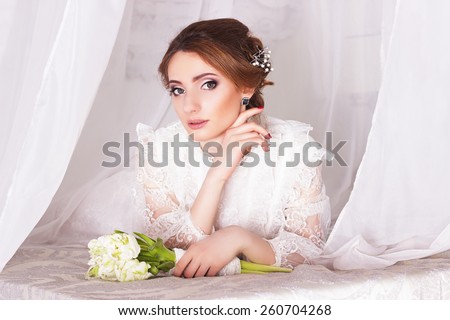 Spring bride dress in vintage style with a bouquet of tulips