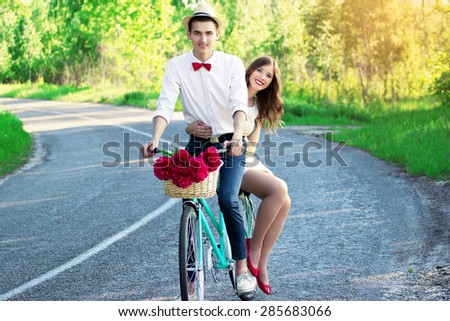 Wedding. Stylish young newlyweds on a vintage bike