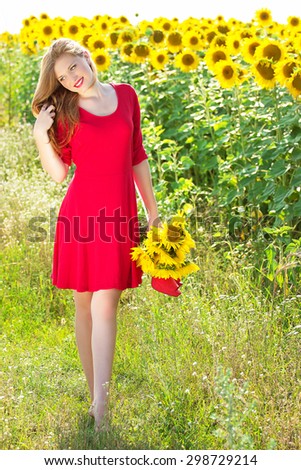 Girl in sunflowers in the red dress