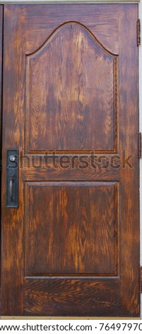 A historic wooden door with handle and lock