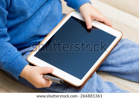 Baby, kid with tablet pc, baby hands holding tablet pc, focus on right hand.