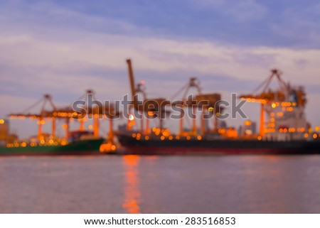 Bokeh of cargo ship background and harbor on twilight.