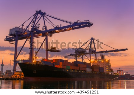 Cargo ship terminal at twilight scene, Unloading crane of cargo ship terminal, Sunrise shot.