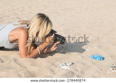 Photographer at work, jewelry photography on the beach.
