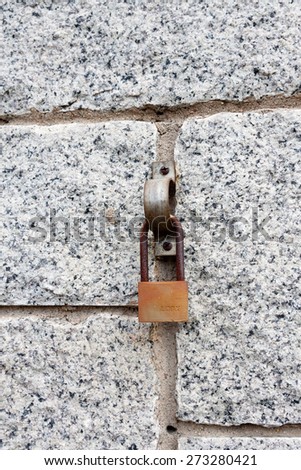 close-up of a stone wall with a lock