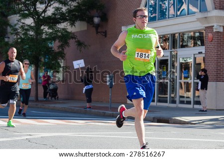 Stamford, CT, USA - June 1, 2014: The individuals are some of the many runners for the cancer awarness marathon in Stamford, CT, June 1, 2014