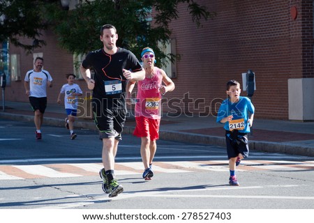 Stamford, CT, USA - June 1, 2014: The individuals are some of the many runners for the cancer awarness marathon in Stamford, CT, June 1, 2014