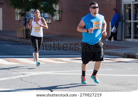 Stamford, CT, USA - June 1, 2014: The individuals are some of the many runners for the cancer awareness marathon in Stamford, CT, June 1, 2014