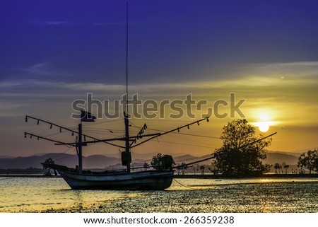 View the fishing boat at sunset