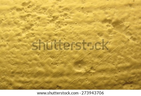 Yellow surface texture similar to the surface of the moon.  Actually a closeup of a lamp.