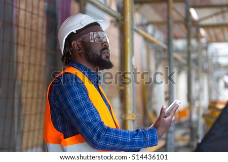 African american engineer wearing safety work wear at construction site