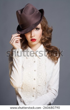 beautiful young woman in hat. stylish fashion girl in white shirt. professional make-up