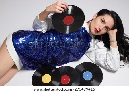 fashion portrait of Young woman with vinyl disc.Retro Disco girl.pop Star