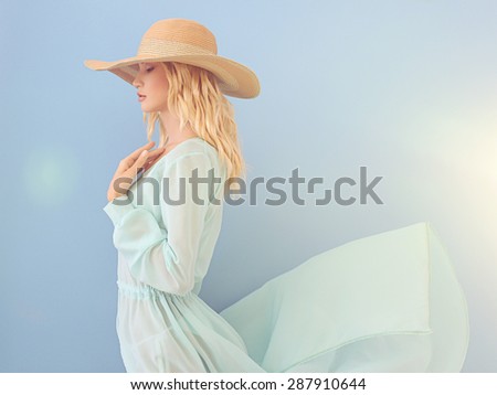 beautiful young woman in hat.summer girl in blue dress