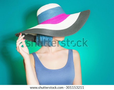 Beautiful young Woman in Hat.Elegance Beauty Girl with blue hair. colorful hat