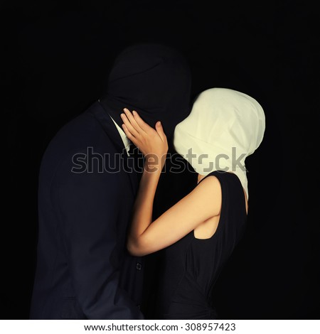 strange kiss.man and woman wearing masks, safe sex concept