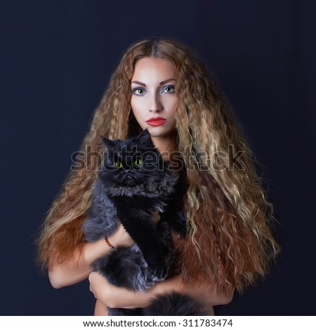 halloween mysterious girl with black cat.beautiful young witch woman