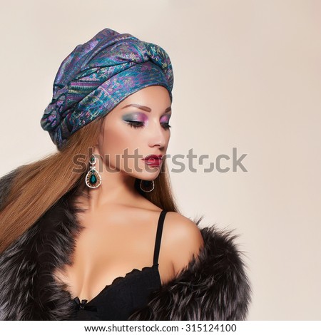 rich Beautiful woman in fur and arabian turban.winter fashion.Beauty sexy Model Girl in Luxury Fur coat and jewelry