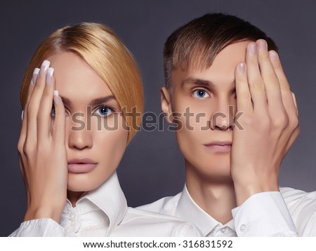 young couple man and woman close their eyes. fashionable beautiful boy and girl together