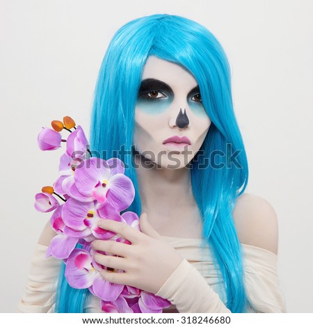 halloween zombie girl with flower.death skeleton make-up.horror woman with blue hair