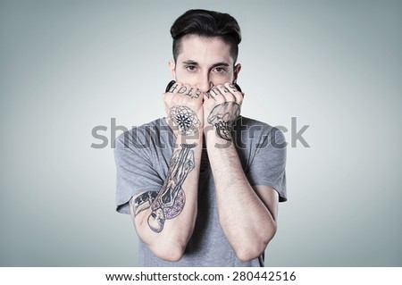 beautiful tattooed man on wall.
