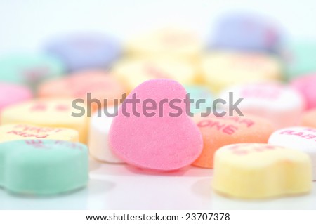 Candy hearts with shallow depth of field. One blank candy heart in focus and ready for custom message or logo.
